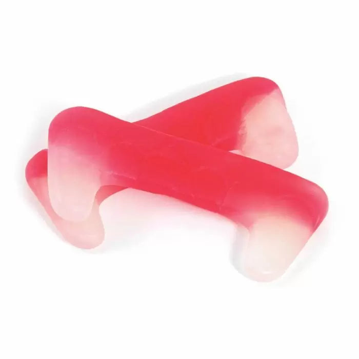 Chewy red vampire fang shaped sweets with glossy finish